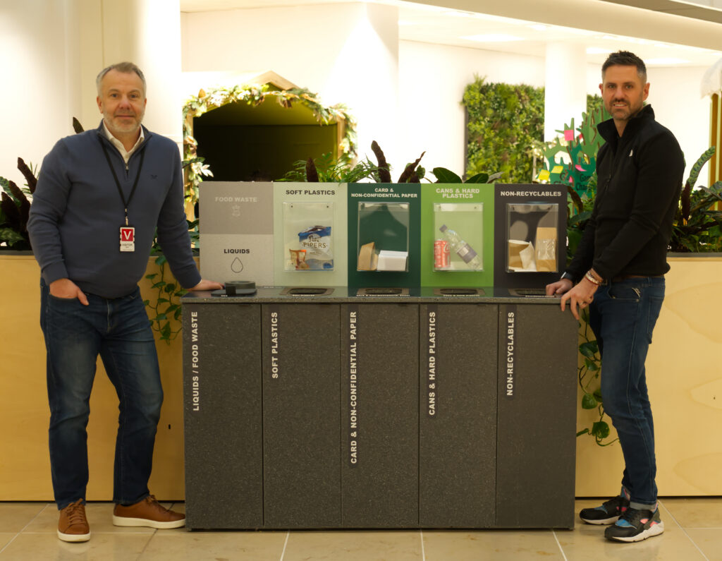 The co-cre8 team alongside the installed bin for life unit